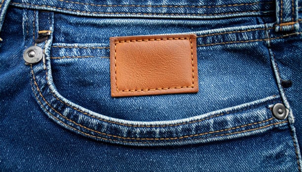 Close Up of Blue Jeans Pocket with Brown Leather Label Fashion and Style photo