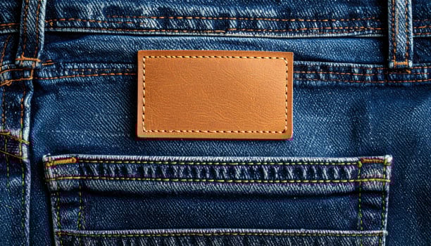 Close Up of Blue Denim Jeans with Brown Leather Patch Pocket on Back photo
