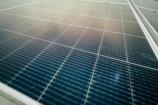 Solar panels installed on a rooftop generate renewable energy during a sunny day in an urban setting photo