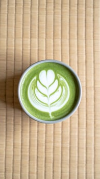 Aerial View of Matcha Latte with Foam Art on Japanese Tatami Mat Background photo