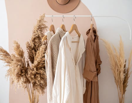 Neutral Colored Clothing on Rack with Pampas Grass and Hat for Adobe Stock photo