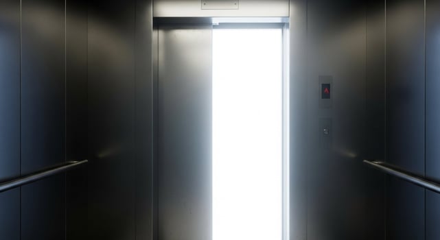 An elevator with a light shining through the door photo