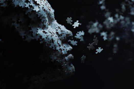 Artistic representation of a face made of puzzle pieces against a dark background at night photo