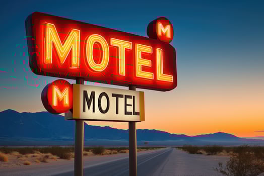 Neon motel sign shining at sunset in the desert photo