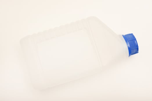 A little plastic bottle. A small plastic canister. A container with liquid. photo
