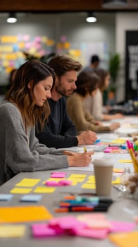 Group brainstorming session with sticky notes and creative ideas at a collaborative workspace photo