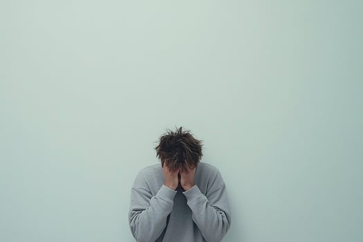 A man is covering his face with his hands photo