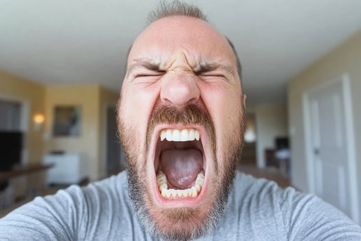A man with his mouth open and a beard photo