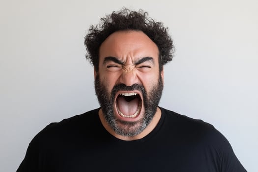 A man with a beard and a black shirt is yelling photo