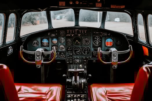 The cockpit of an airplane with red seats photo