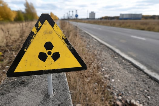 A radioactive sign is on the side of a road photo