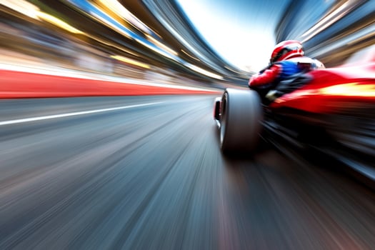 A racing car is speeding down a track photo