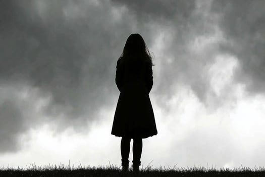 A woman standing in front of a stormy sky photo