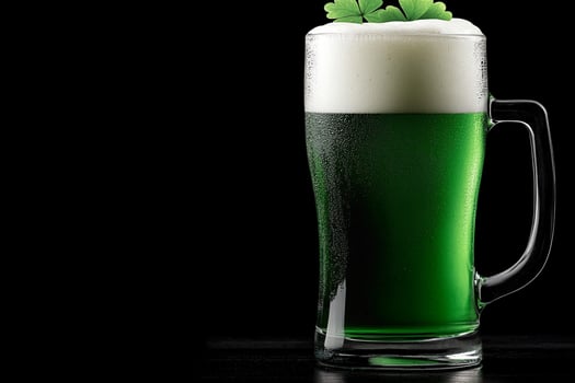 A glass of green beer with a clover leaf photo