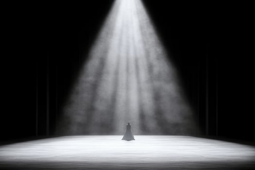 A woman stands in the middle of a dark room photo