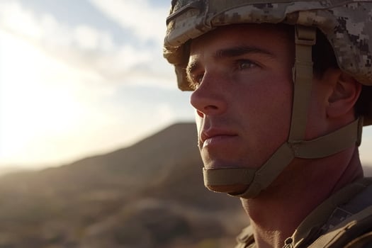 A soldier in uniform looks off into the distance photo