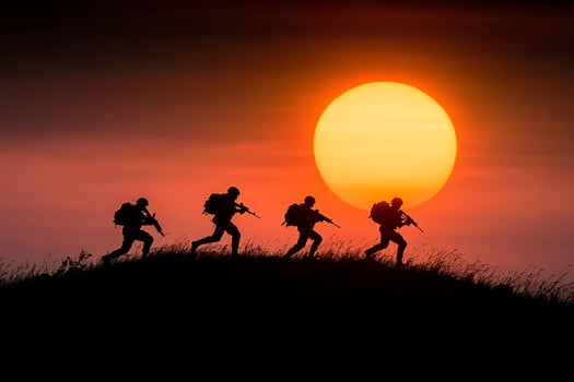 Silhouette of soldiers running in the sunset photo