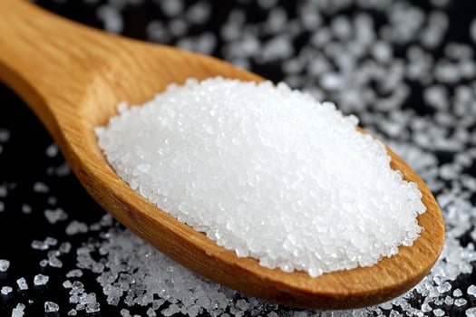 A spoon full of sugar on a black background photo