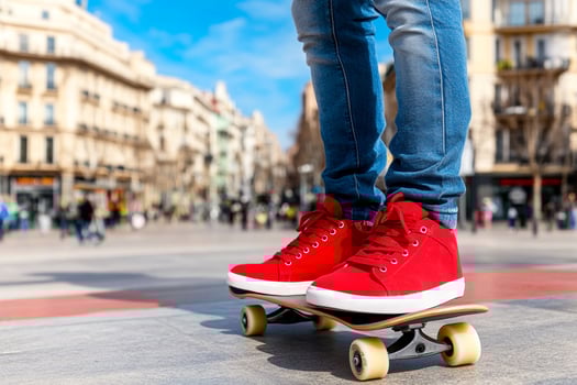 A person riding a skateboard with red shoes photo