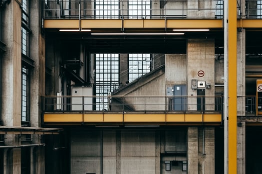 A view of a large industrial building with yellow beams photo