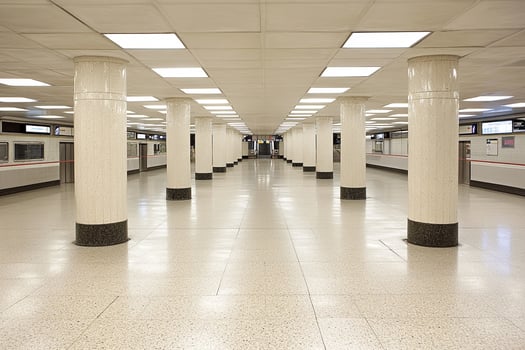 A long hallway with columns and a train photo