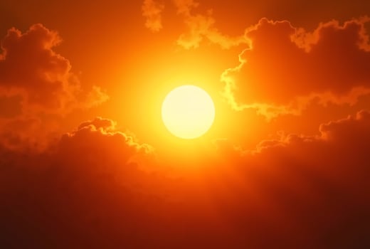 The scorching sun in the clouds. Global warming. The concept of rising temperatures. photo