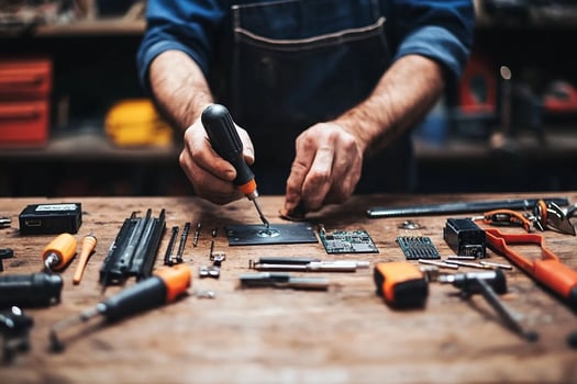 A man is working on a computer with tools photo