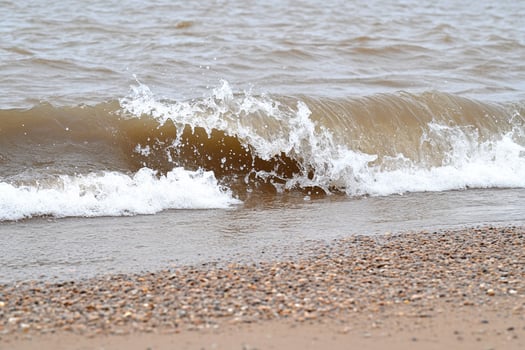 A person is riding a surfboard on a beach photo