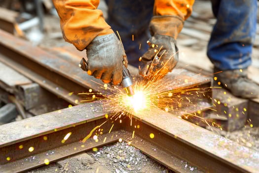 A person welding on railroad tracks photo