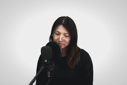 A woman singing into a microphone photo