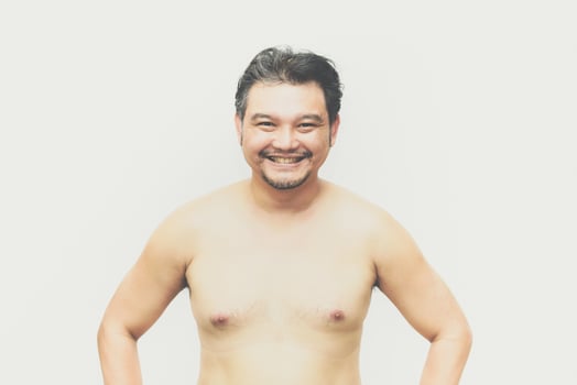 A man with no shirt on standing in front of a white background photo