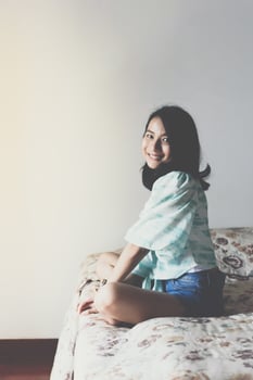 A woman sitting on a bed photo