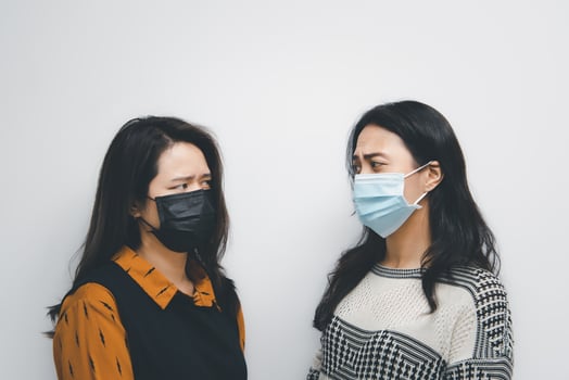 Two women wearing face masks photo