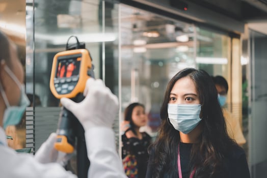 A woman wearing a face mask and a man wearing a mask photo