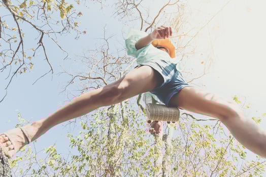 A person jumping off a tree trunk photo
