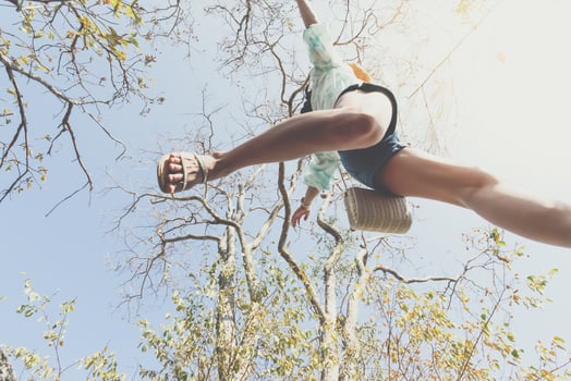 A person jumping in the air with their legs up photo