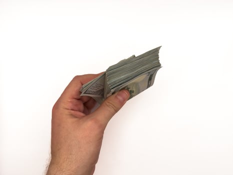 USA dollars, US money, cash, salary in dollars, dollar, mans hand is holding a stack of US dollars, copy space photo