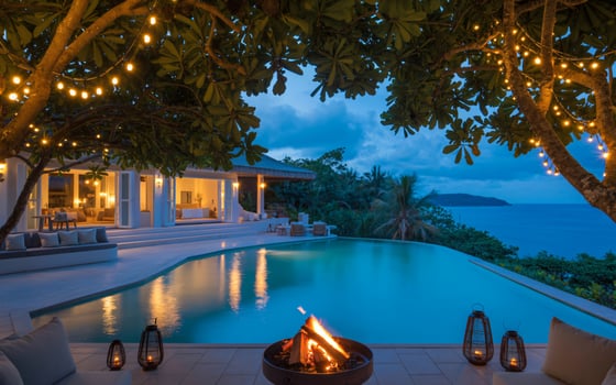 Luxury tropical villa with infinity pool and fire pit at dusk photo