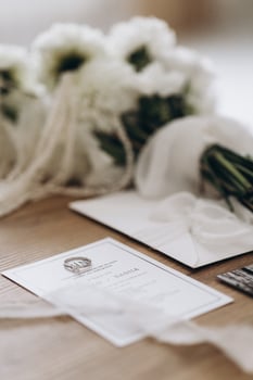 Wedding details wedding rings, invitations and floral arrangements photo