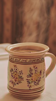 Steaming Hot Coffee in a Beautiful Floral Mug for a Cozy Morning. photo