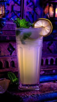 Refreshing Lemonade With Mint and Ice, Lit by Moody Blue and Purple Lights. photo