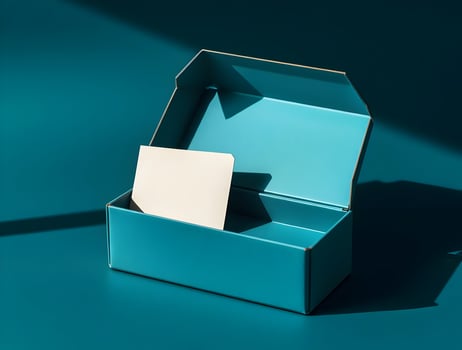 A blue box with a white piece of paper inside photo