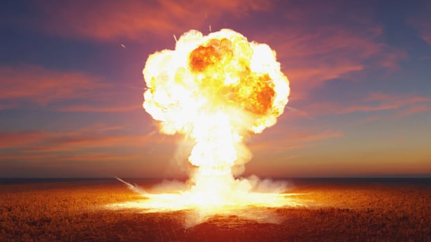 Bright Explosion with Fiery Orange Mushroom Cloud at Dusk photo