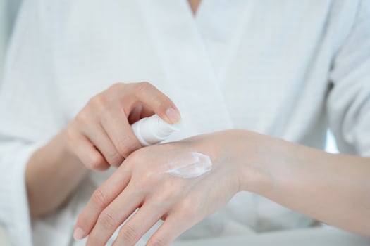 Beautiful Asian woman smile use cream for good skin. healthy woman apply cream for body. Advertisement for skin cream, anti-wrinkle, baby face, whitening, moisturizer tighten pores serum. photo