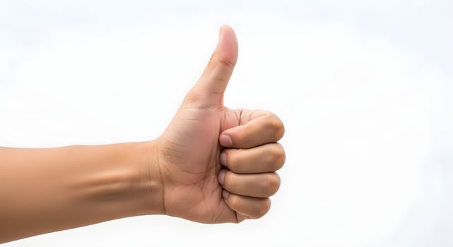 A person's hand giving the thumbs up sign photo