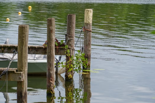 A boat tied to a dock photo