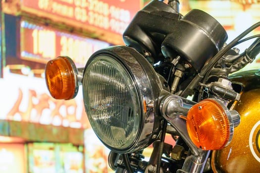 A close up of a motorcycle with a neon sign photo