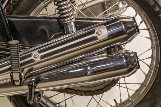 A close up of a motorcycle with a chrome exhaust pipe photo