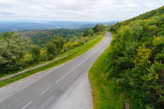 Road trip concept a curved road in the green hills of Galicia, Spain. photo