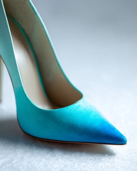 Sophisticated single ombre stiletto in frosty blue tones with glossy finish, soft focus lighting, blurred white background, perfect for editorial or branding visuals photo